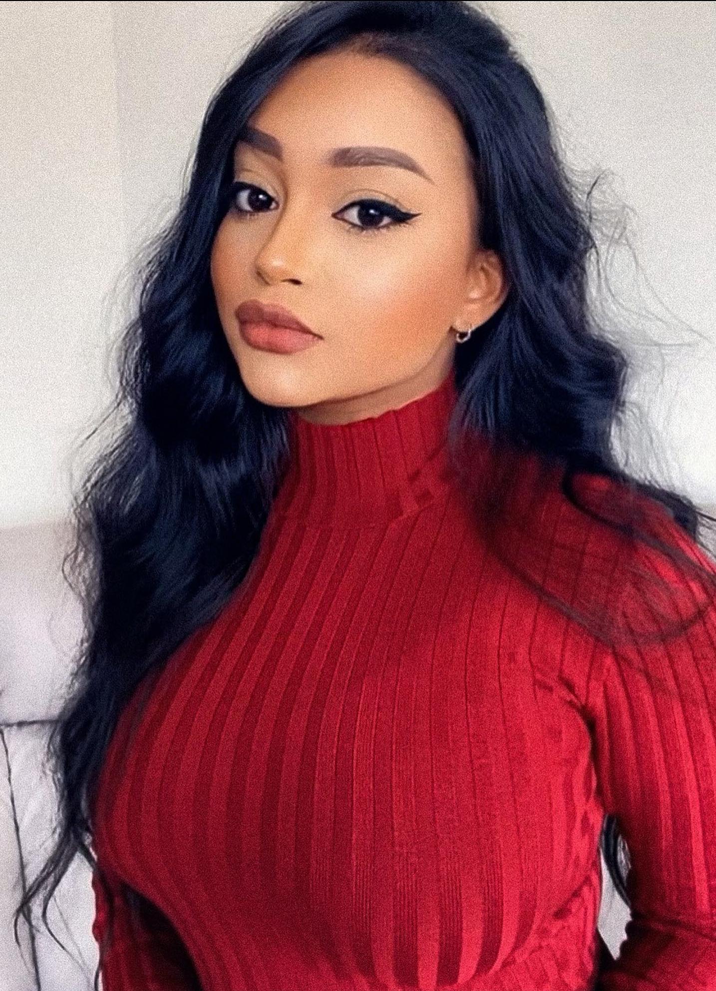 Busty mixed woman in a white shirt and ripped jeans, red turtleneck, and sheer blouse with a denim skirt