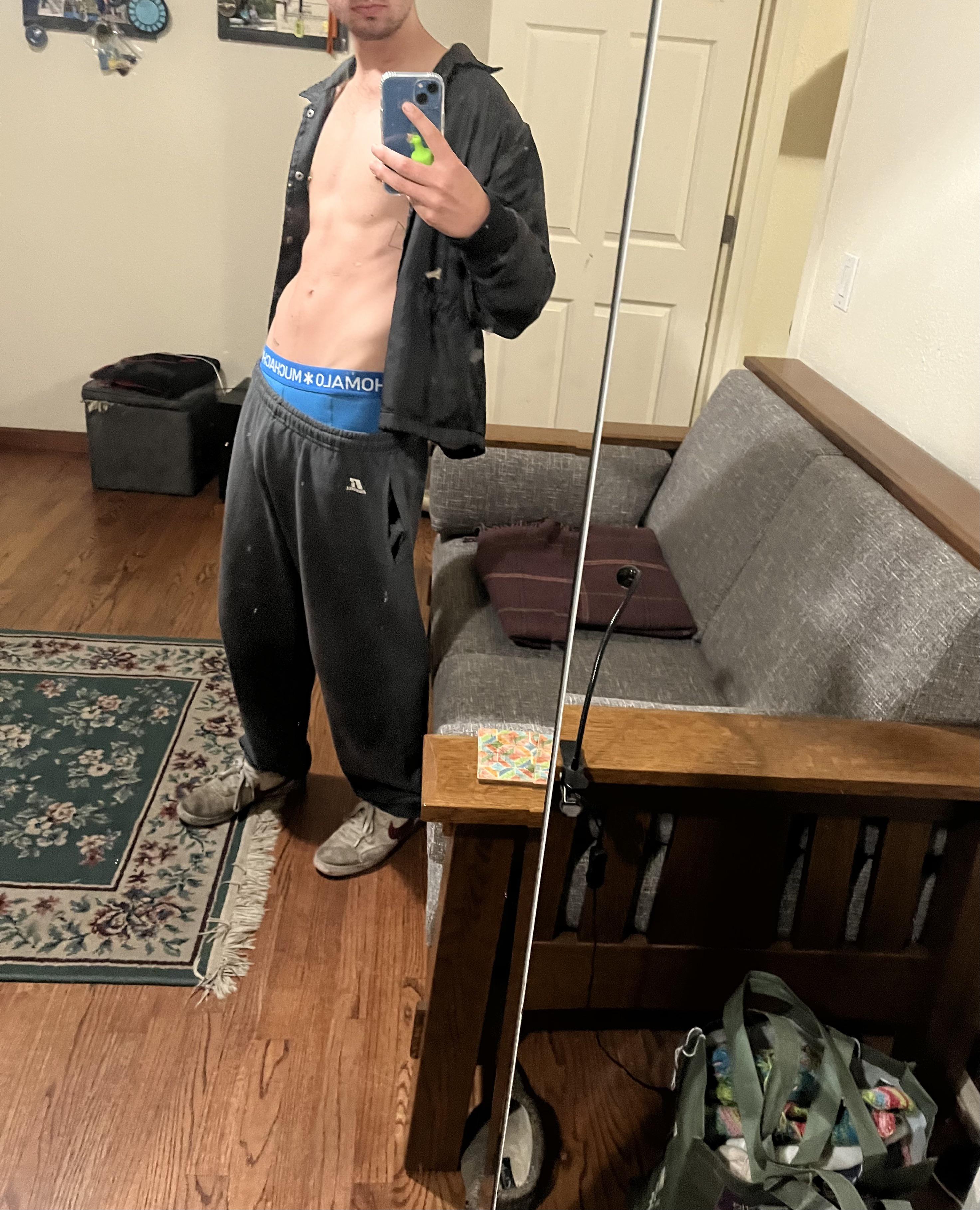 Athletic white man in a mirror selfie showing his uncut cock and abs