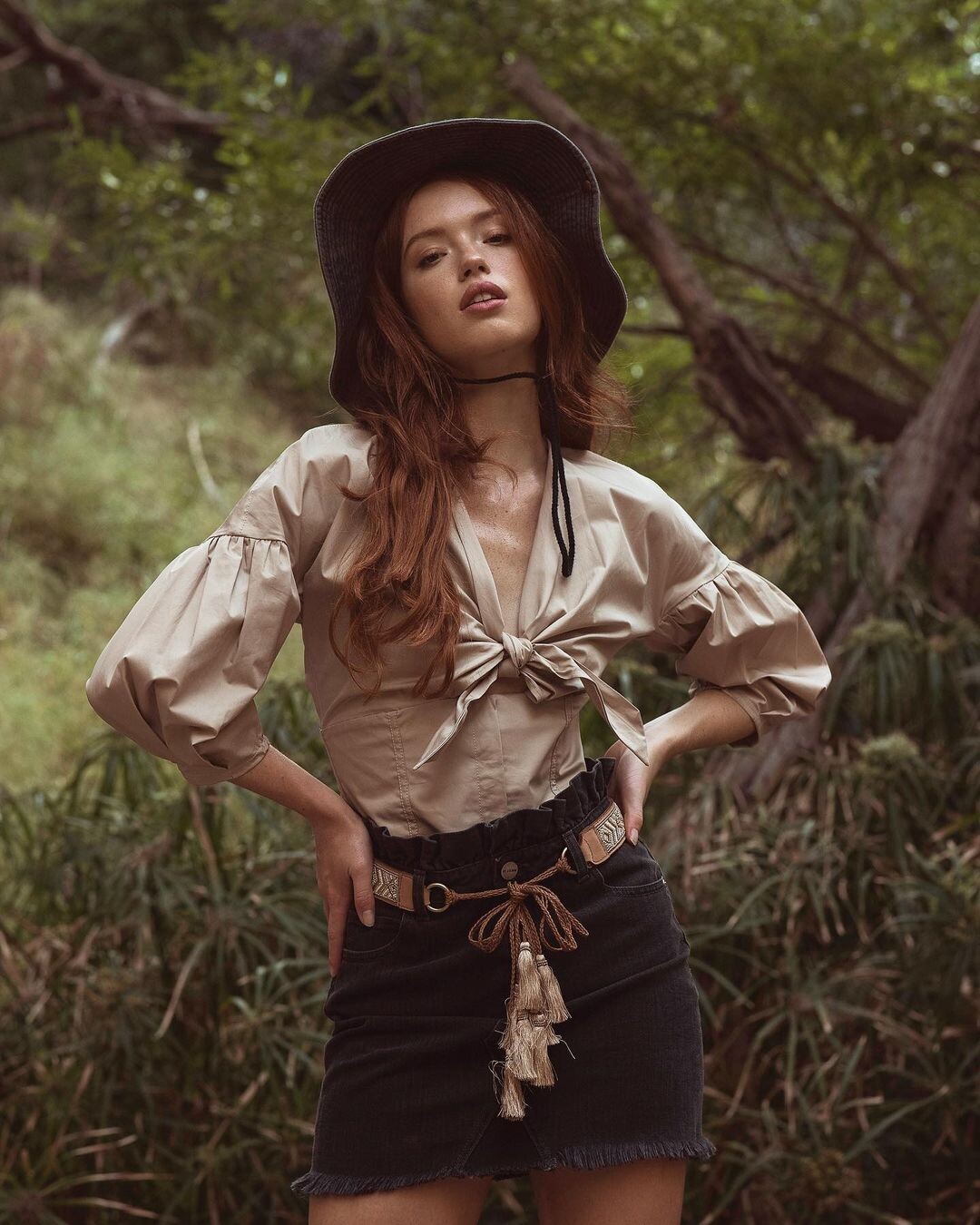 Riley Rasmussen, a redheaded goddess, in a bikini, blouse and skirt, turtleneck, and denim shirt.