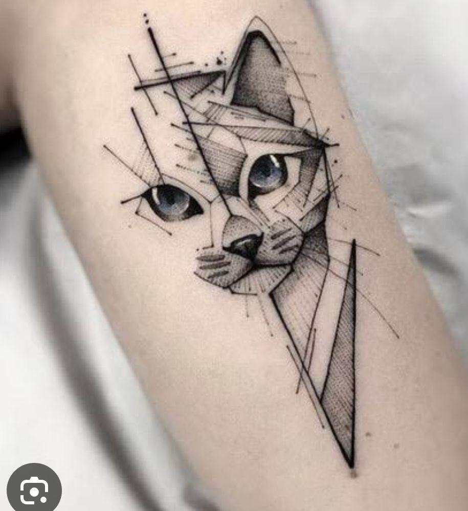 Geometric cat tattoos on light skin, featuring fine line tattoo inspiration and abstract animal drawings.