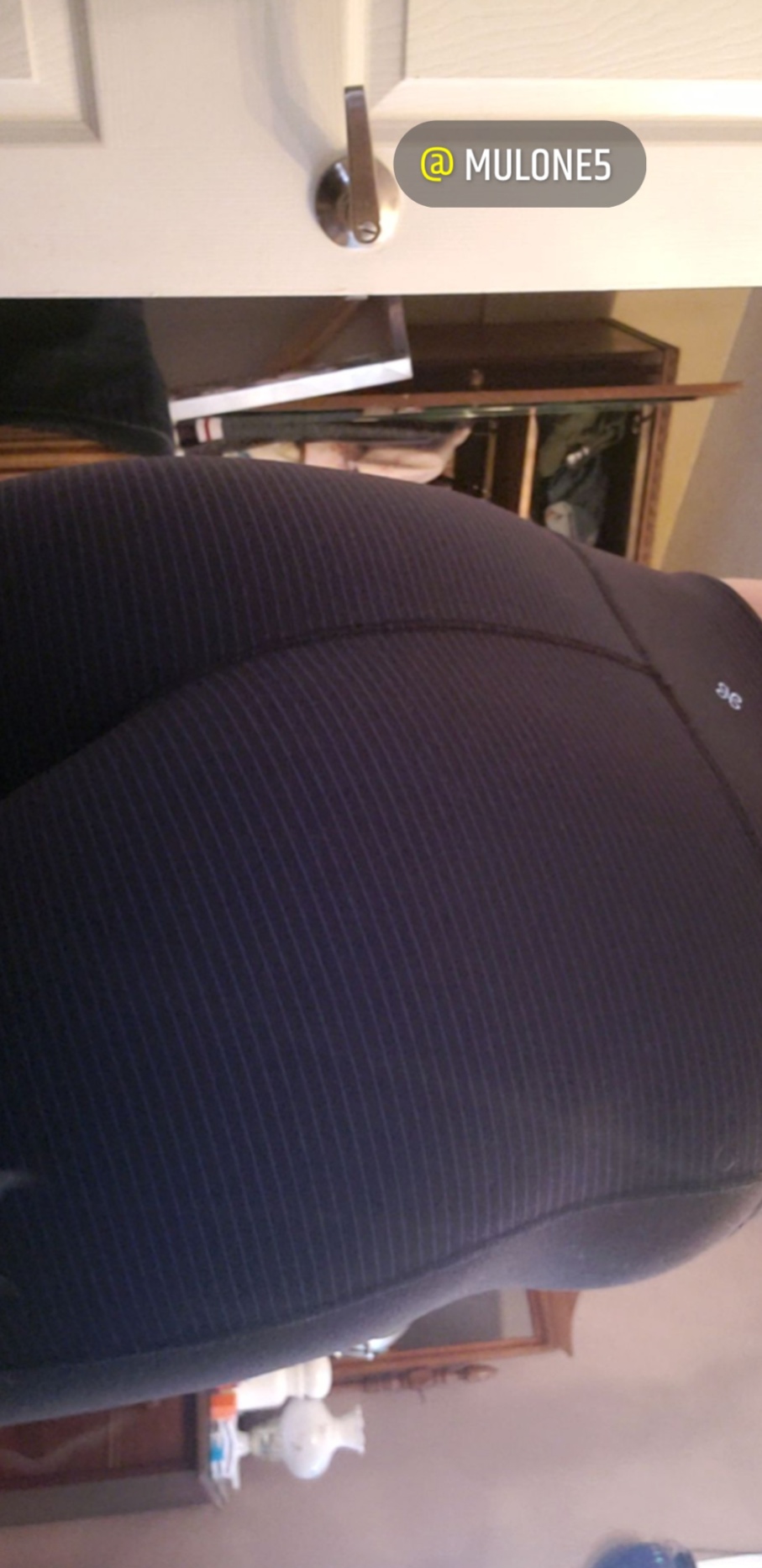 Curvy woman in tight black ribbed leggings posing to highlight her wide hips and ass