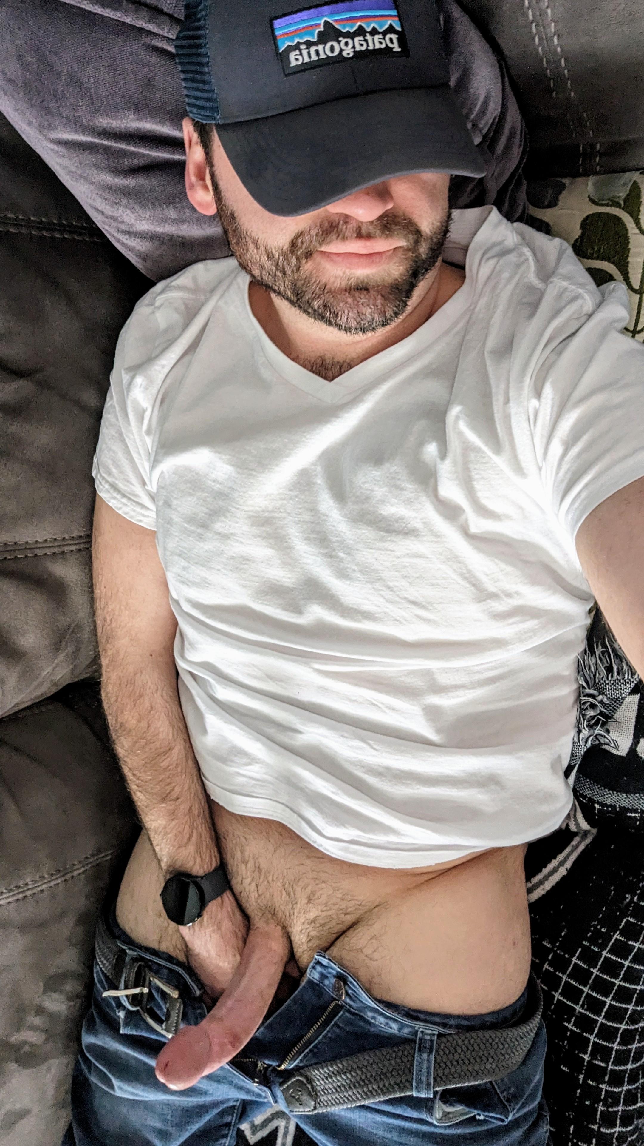 Sinnogonic posing for pelfies, exposing his uncut white cock while wearing a white t-shirt and baseball cap
