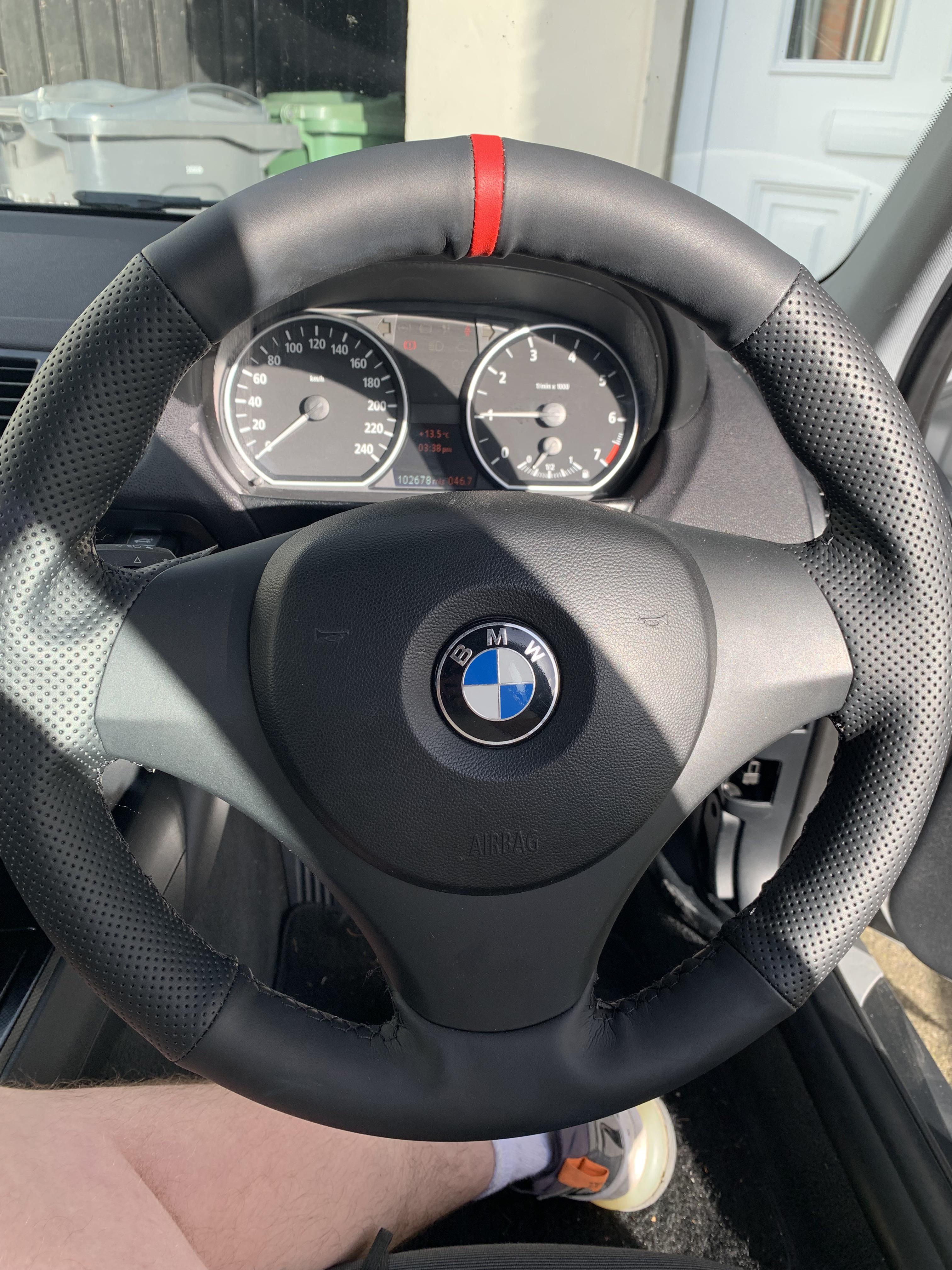 Silver BMW 120i car exterior and interior footwell with pedals