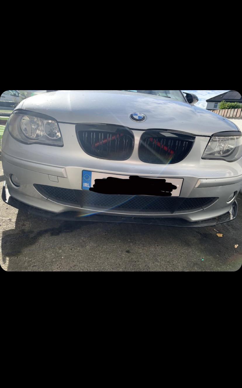 Silver BMW 120i car exterior and interior footwell with pedals