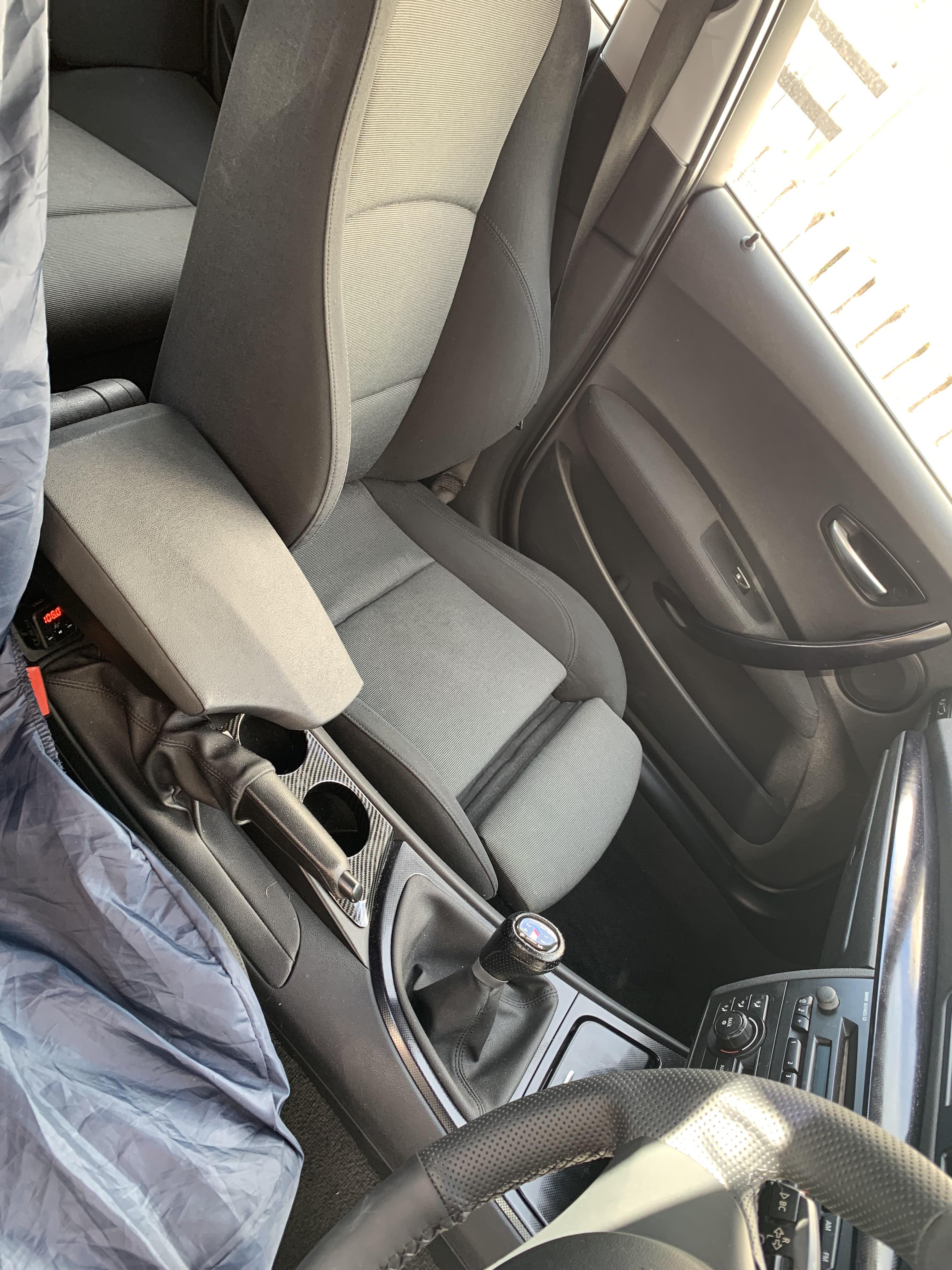 Silver BMW 120i car exterior and interior footwell with pedals