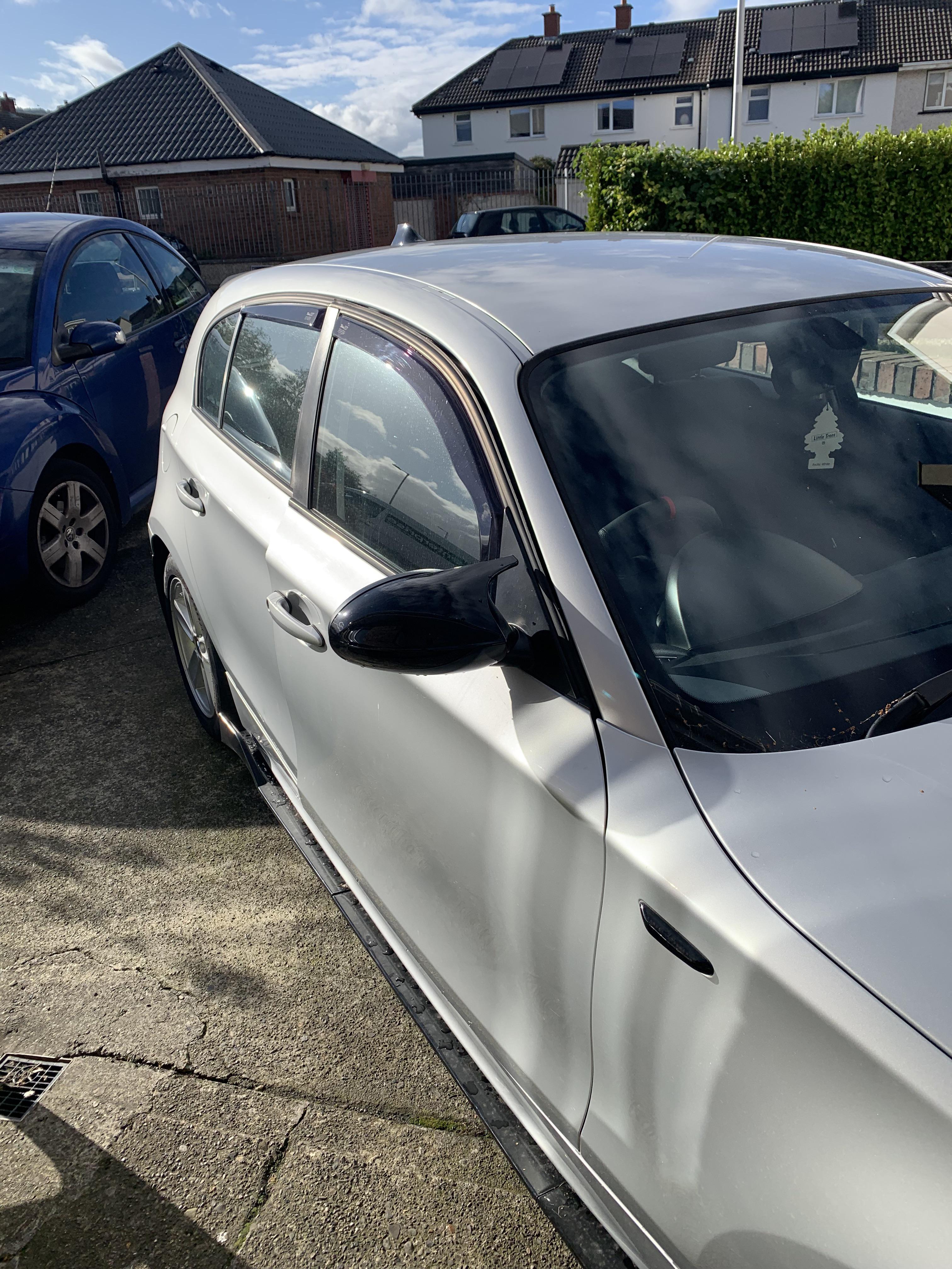 Silver BMW 120i car exterior and interior footwell with pedals