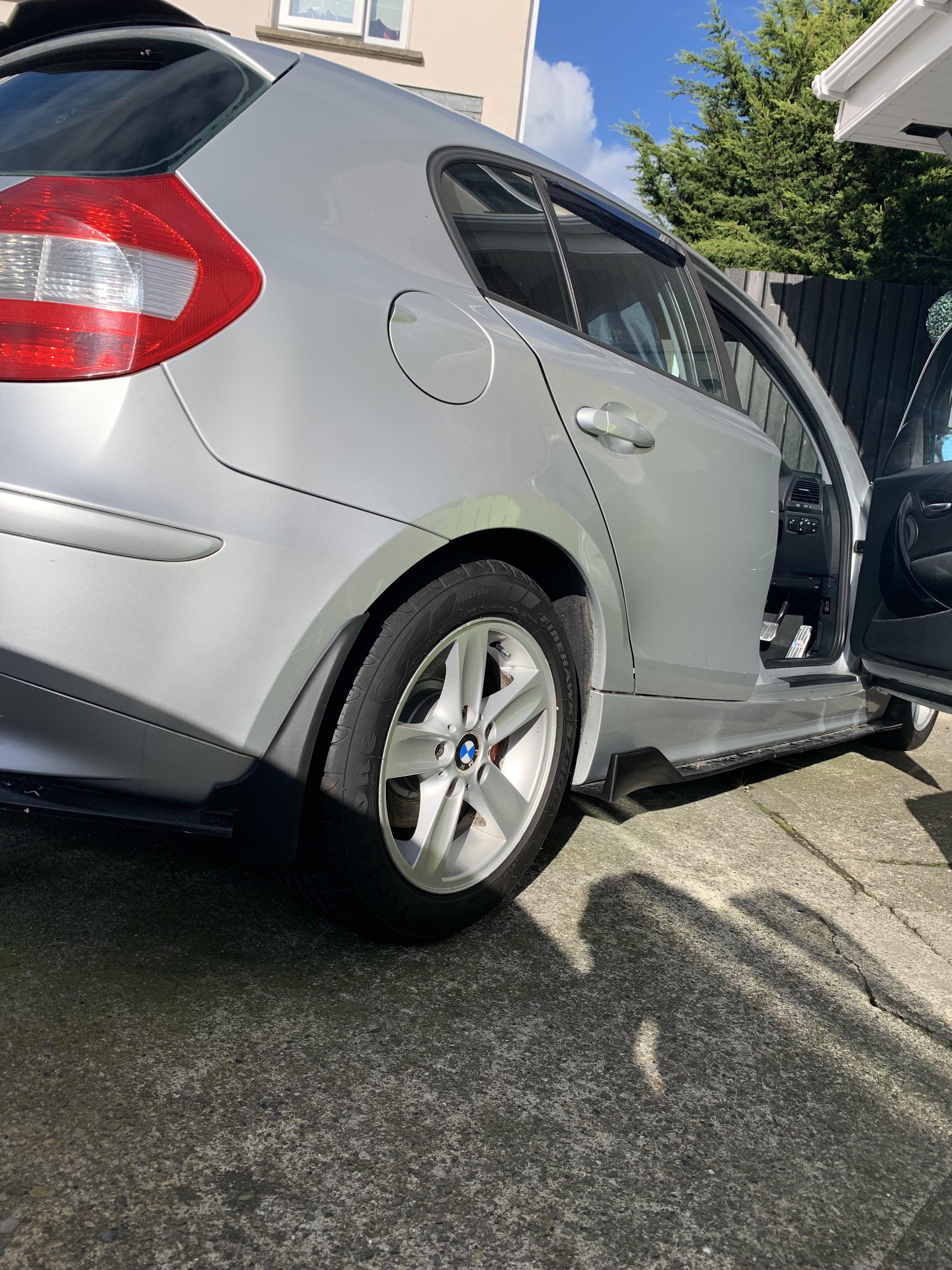 Silver BMW 120i car exterior and interior footwell with pedals