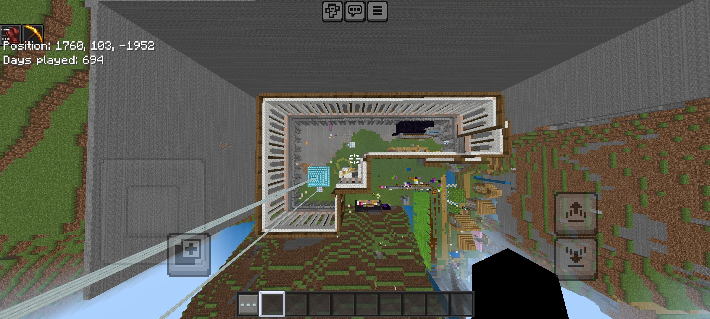 Minecraft mega build of a large wooden mansion situated among green hills and mountains.