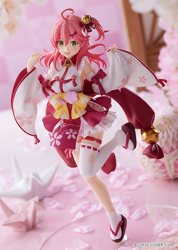 Sakura Miko anime figure with pink hair in a red and white kimono-style dress with yellow bows