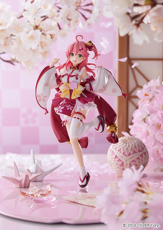 Sakura Miko anime figure with pink hair in a red and white kimono-style dress with yellow bows