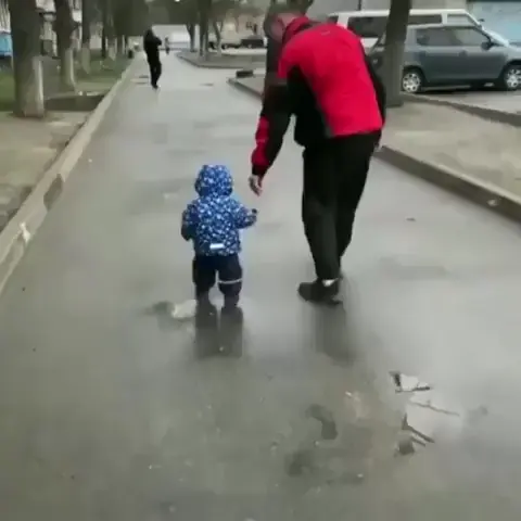 A small kid in Ukraine is afraid of an air raid siren and tries to hide in the arms of his dad.