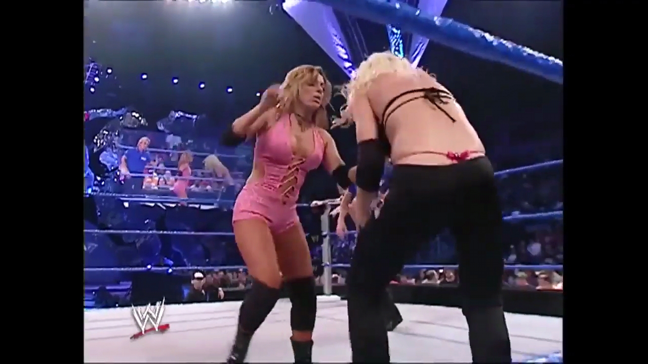 Torrie Wilson in a pink bikini and thong during a WWE wrestling match