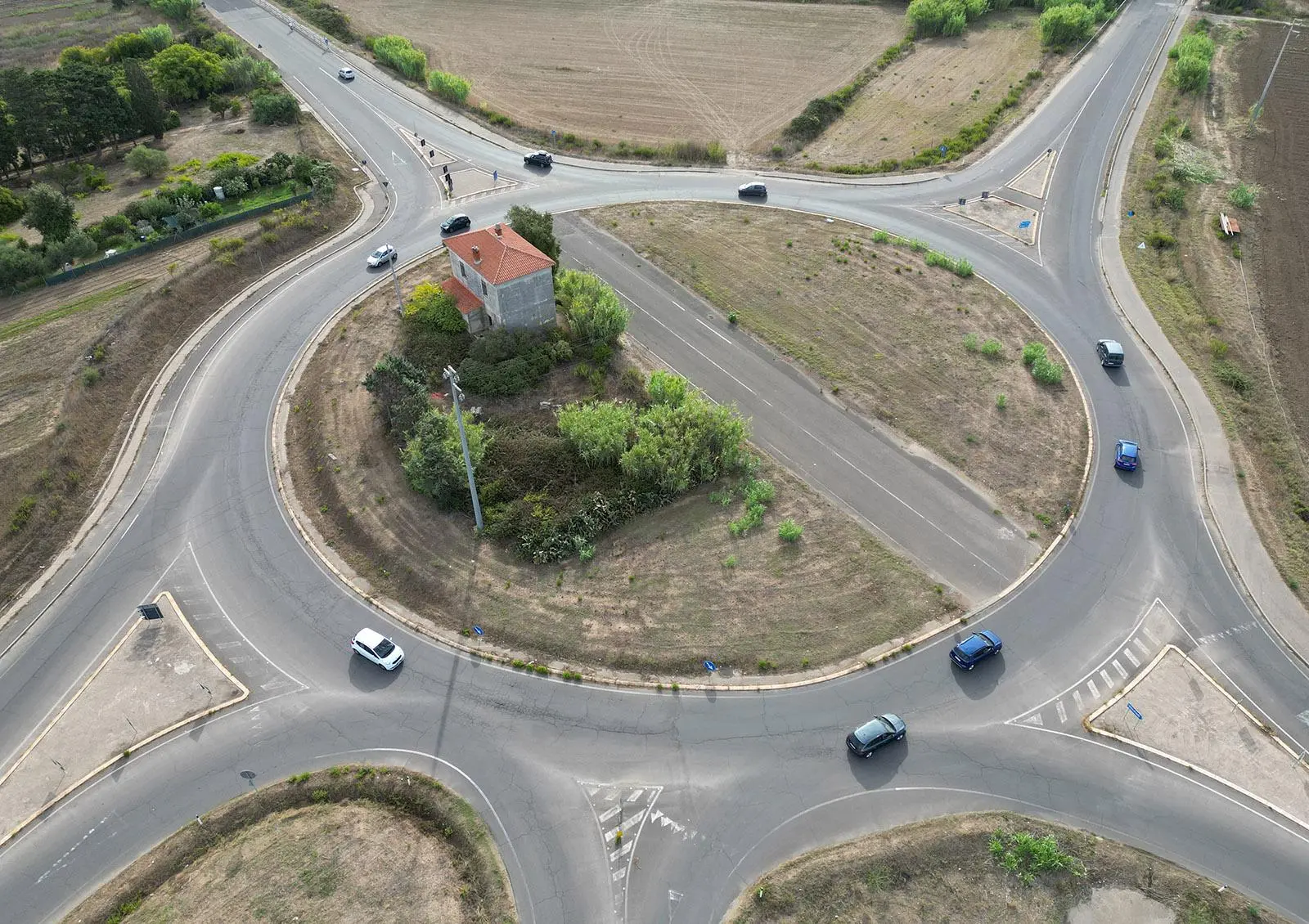 An abandoned house in the middle of a roundabout in Sardinia, Italy ...