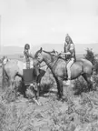 Portrait of two native Americans, one adult and one child, sitting on horses, photograph taken from a stereoscopic print , 1880