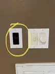 What is this black rectangular thing on the wall of our house? There’s a bunch of electrical stuff behind it, so it’s not just a cover.