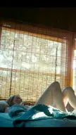 Emma Stone in a yellow bra and light blue panties waking up in a rustic wooden room
