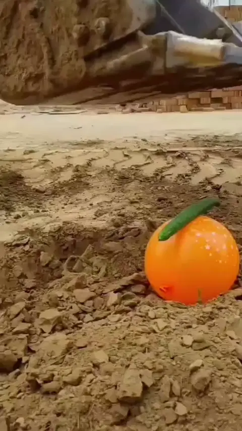 Bulldozer operator performing tricks like cutting cucumber on a balloon, inserting needle into another needle and balancing beer bottles on a thread.