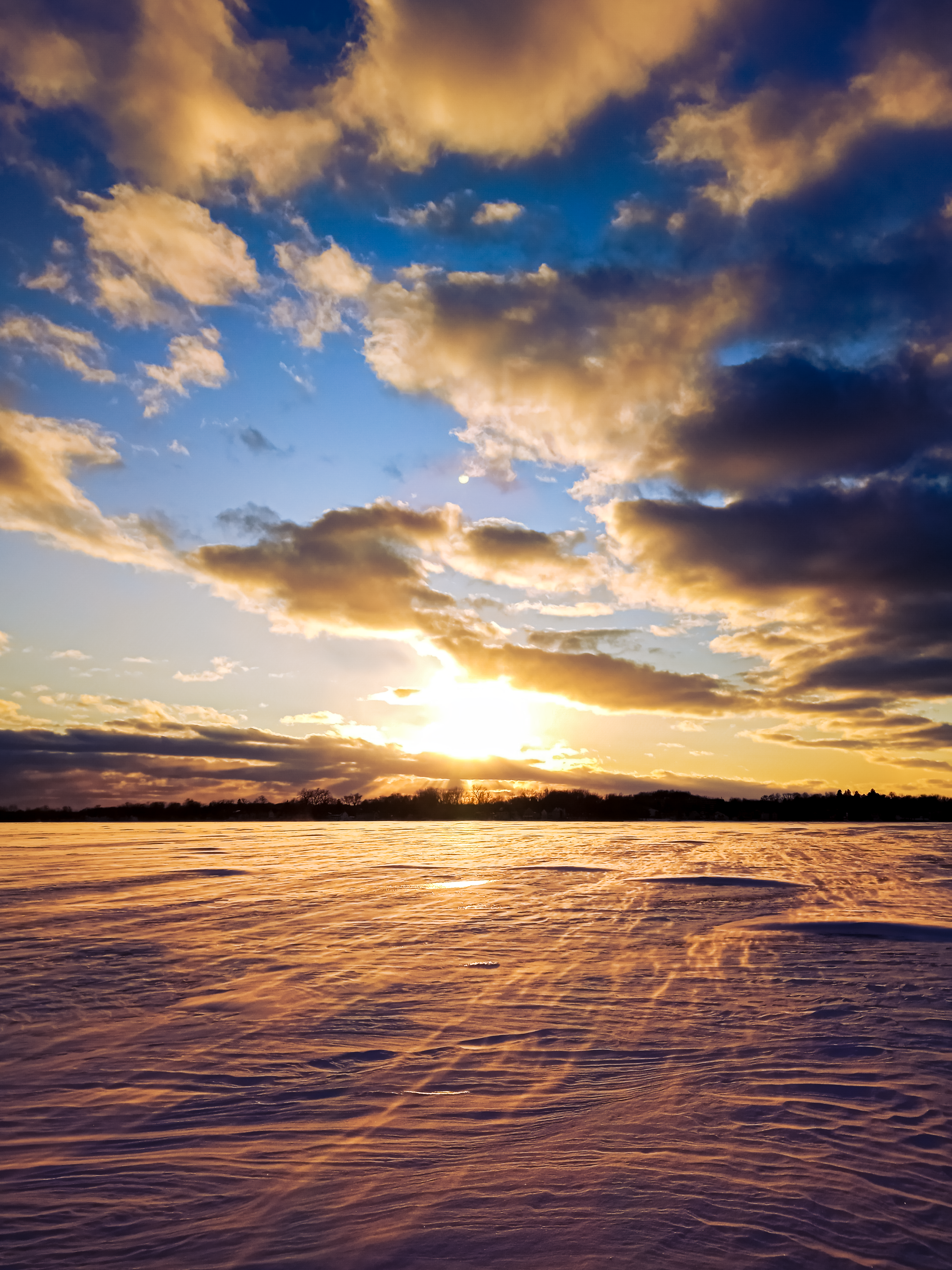Sunset on a frozen lake which resembles the moon's surface (March 2022) [OC]