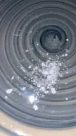 Close-up of white cocaine crystals on a grey spiral-patterned ceramic plate