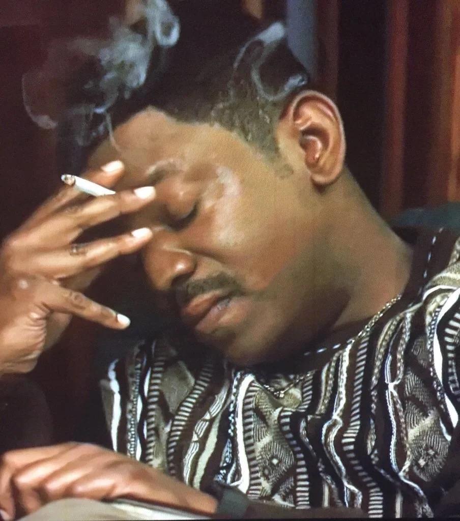 Bobby Brown in streetwear, formal suits, and with a woman in a red dress