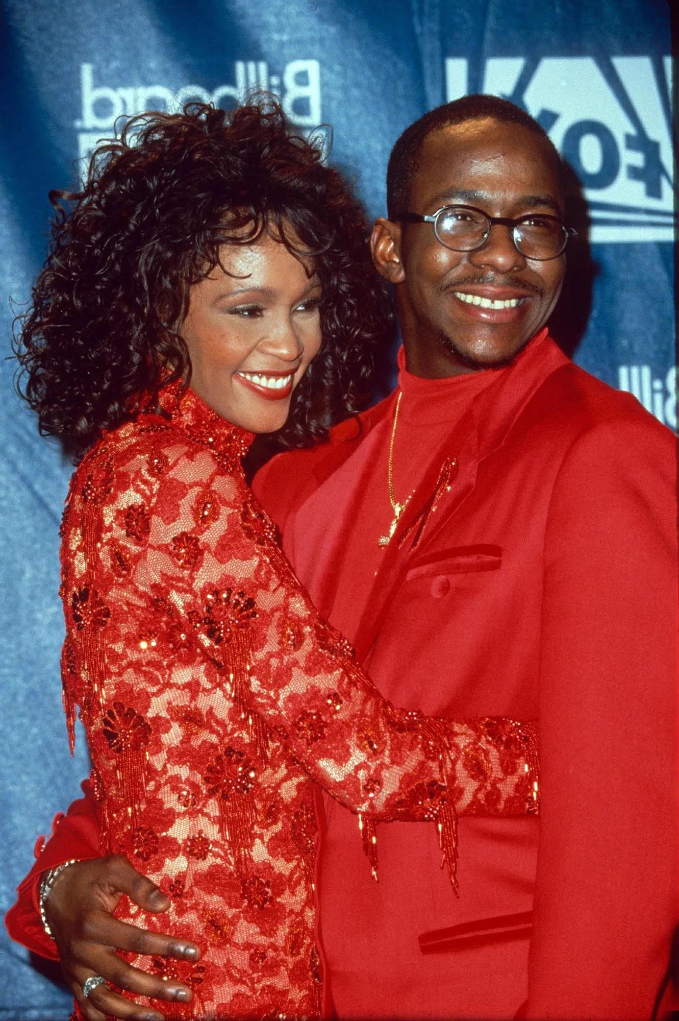 Bobby Brown in streetwear, formal suits, and with a woman in a red dress