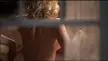 Elisha Cuthbert in red panties moving in front of a window in The Girl Next Door