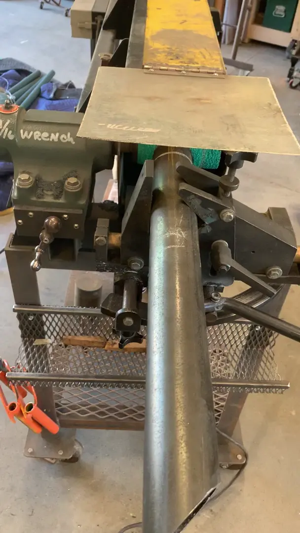 Coping machine. It lets you notch various diameters of pipe at various angles to intersect pipe. Kind of wish it would allow me to post a picture as well.