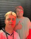 Papaplatte and a fan posing for a selfie with red markings on their faces