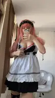 Busty Asian woman in a maid cosplay with a pink wig doing a titty drop mirror selfie