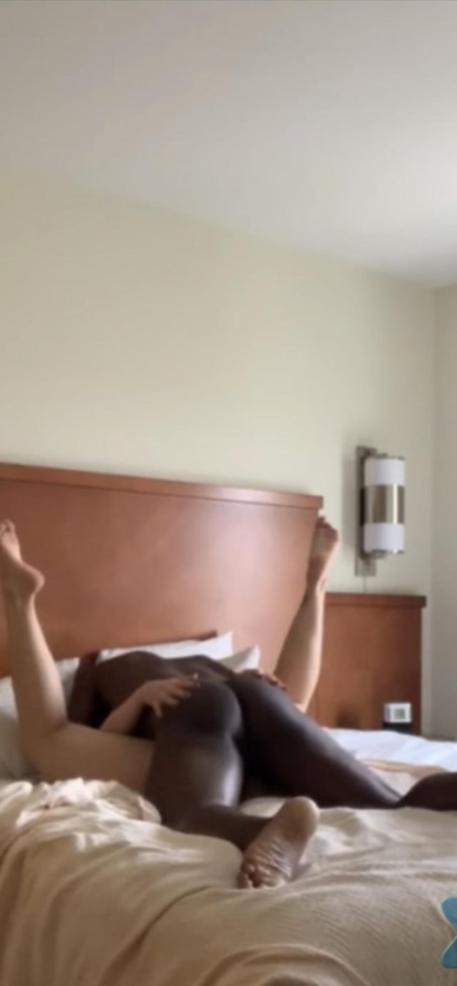 BBC interracial sex with a slim white woman in doggy style with legs up on a hotel bed.