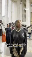 Paola Locatelli in a shiny black metallic hooded dress and gold chainmail at a Rabanne fashion show in Paris