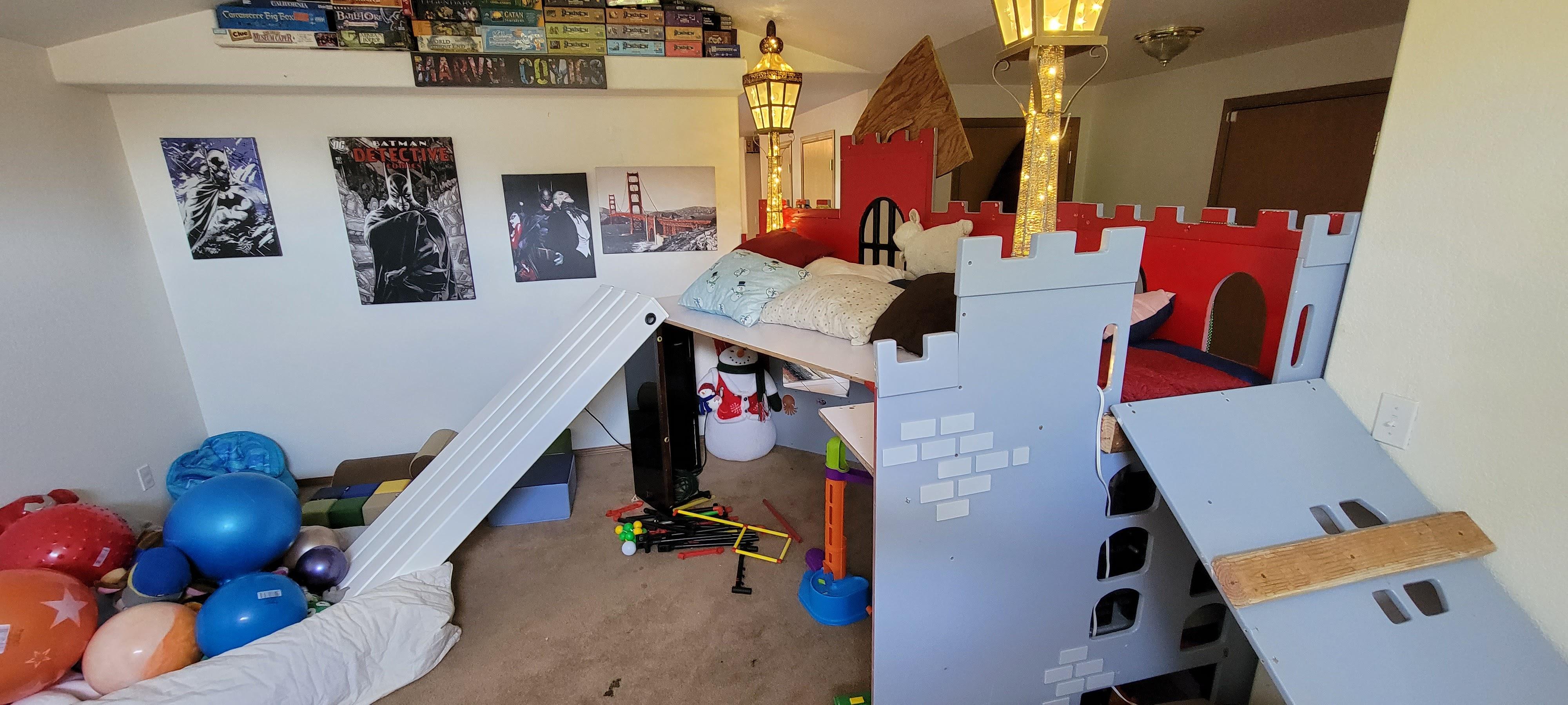 Child's bedroom in Lacey, WA featuring a custom castle bed, lamps, pillows, and stuffed animals.