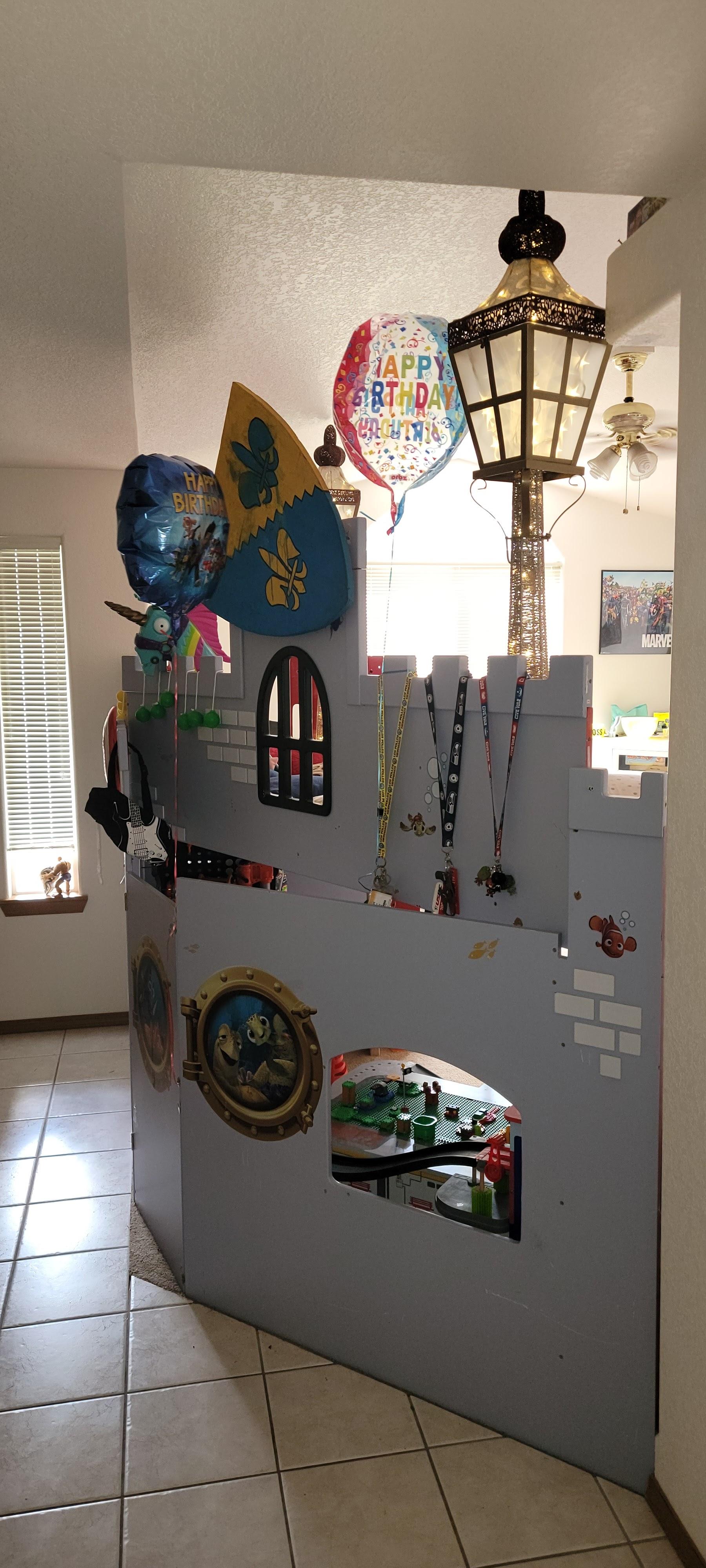 Child's bedroom in Lacey, WA featuring a custom castle bed, lamps, pillows, and stuffed animals.