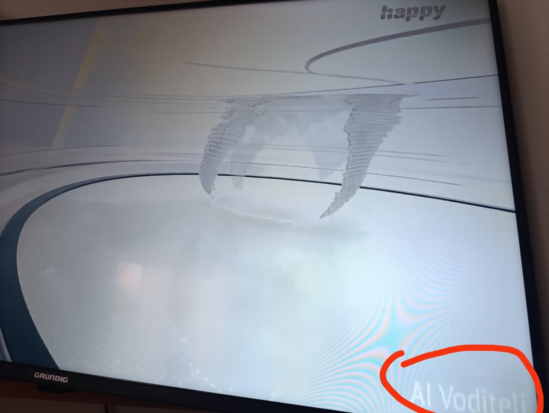 AI slop on a Grundig television screen featuring a weird abstract 3D graphic and the word happy