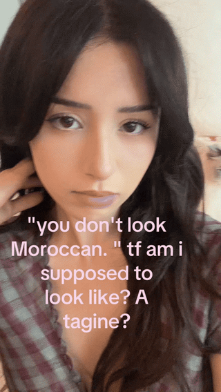 Poki in a brown and white checkered dress reacting to a comment about her Moroccan heritage on TikTok
