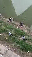 Two fishermen clearly don't give a fuck about the dead body in the river while still fishing beside the crops.