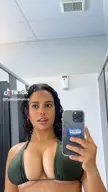 Tyahlamunro in an olive green bikini taking a mirror selfie for TikTok