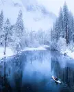 Winter kayaking on the Merced River flowing through Yosemite Valley, Yosemite National Park, California.