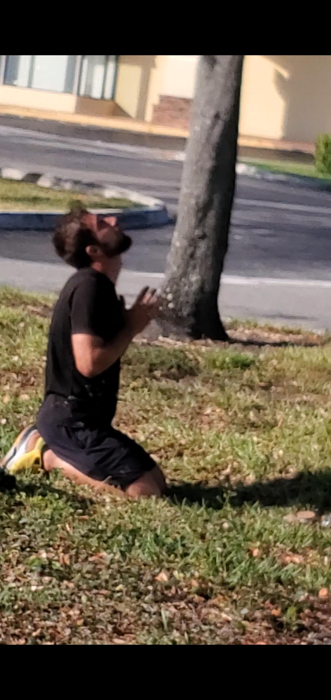 This guy was in the Walmart parking lot praying to a street lamp.