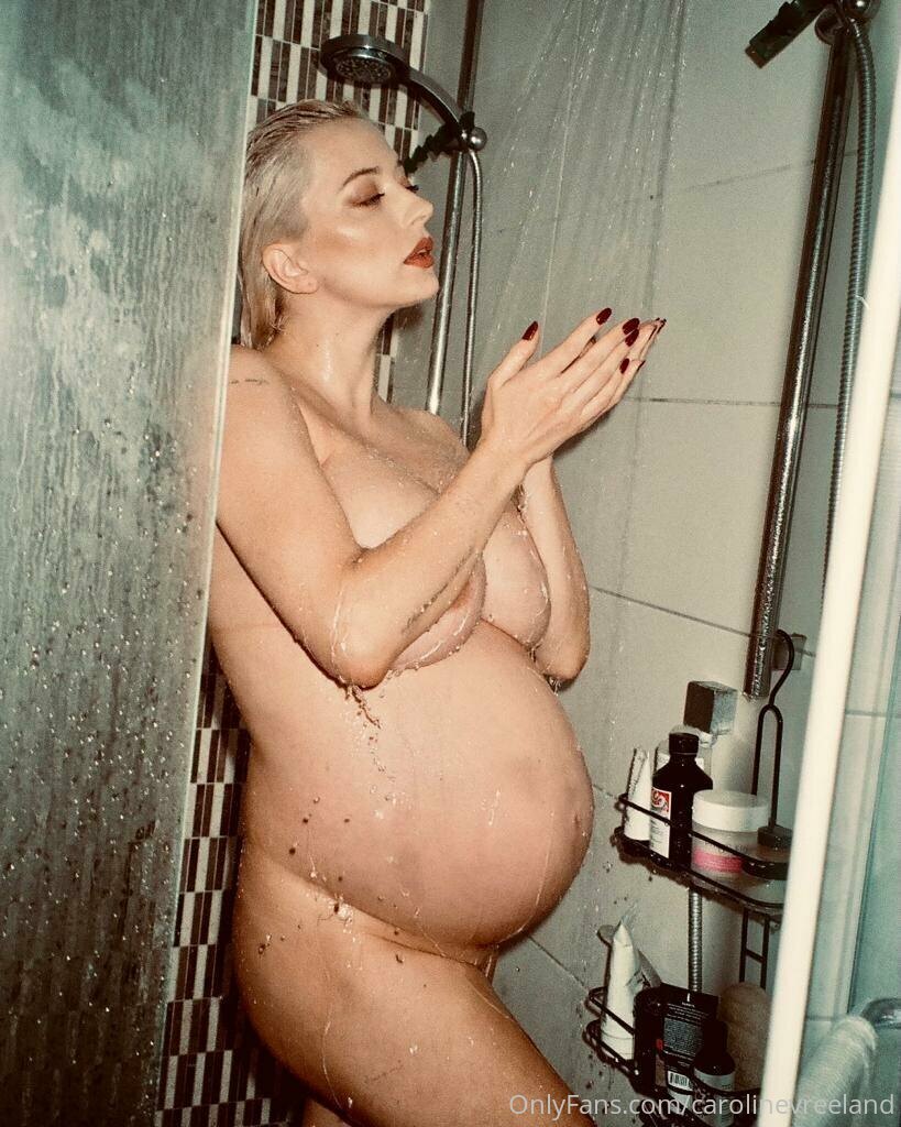 Caroline Vreeland posing nude and pregnant in a shower with a glass of wine