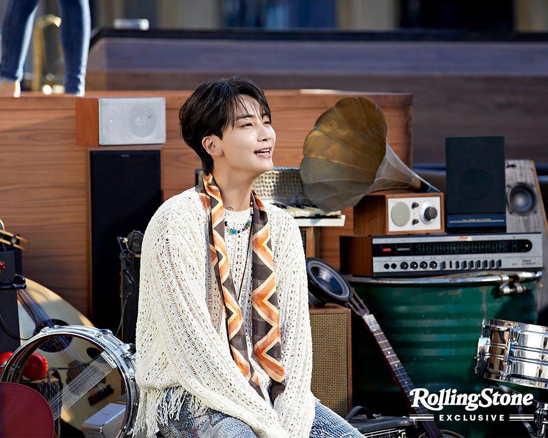 SEVENTEEN kpop idols in 2000s style streetwear, wearing cardigans, ripped blue denim jeans, and colorful knitwear.