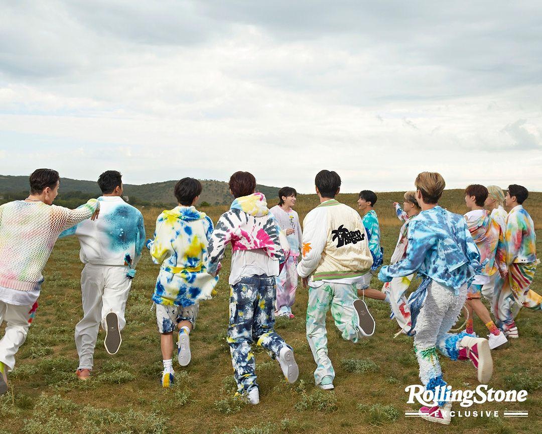SEVENTEEN kpop idols in 2000s style streetwear, wearing cardigans, ripped blue denim jeans, and colorful knitwear.