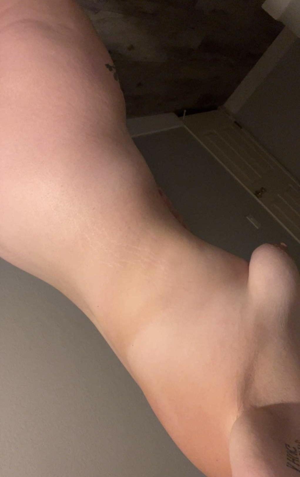 Slim white slutwife posing for a selfie to show her naked ass, thighs, and tattoos.