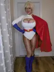 Jazmyne Day as Power Girl in a white spandex bodysuit, red cape, and blue boots