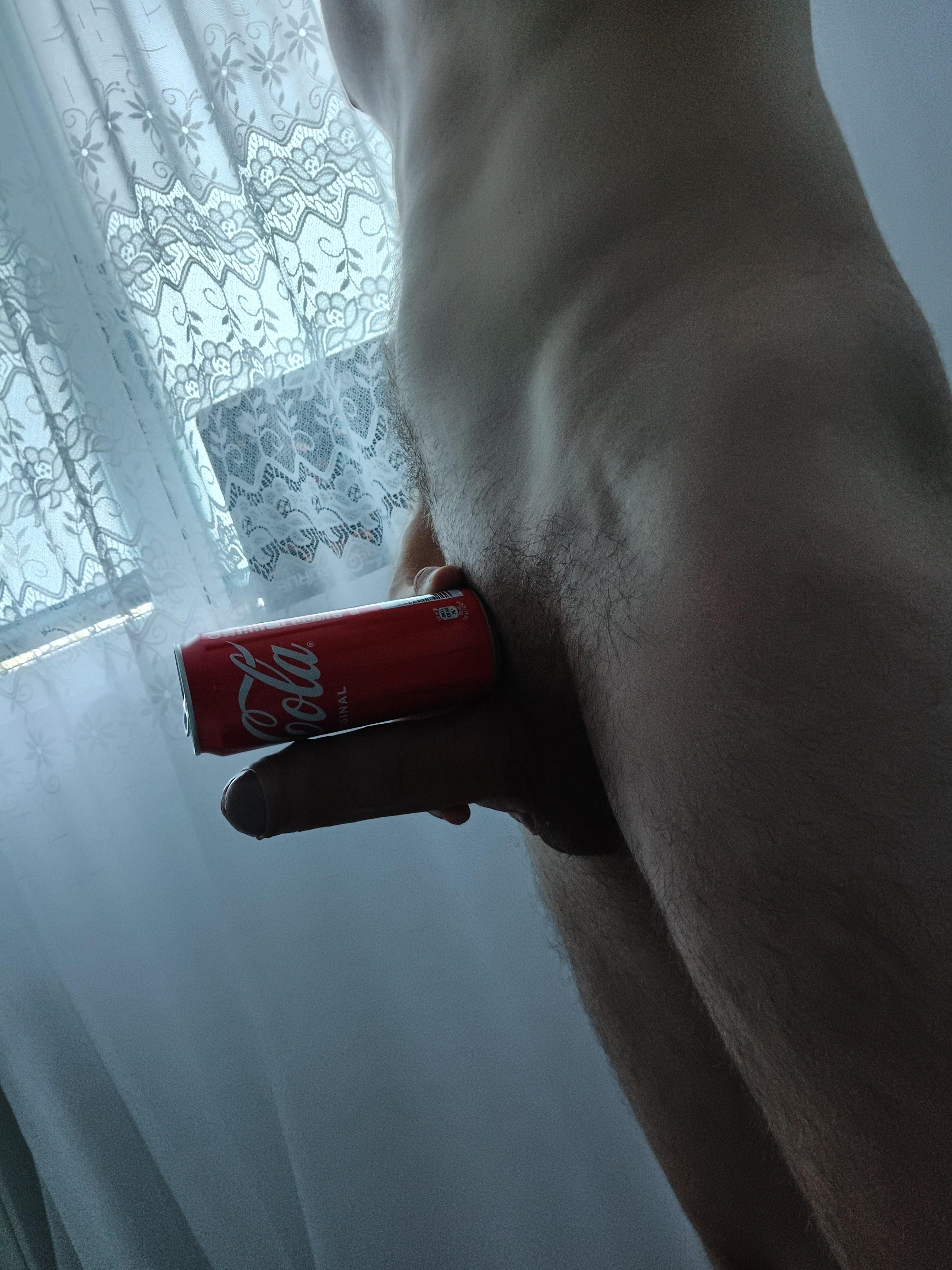 Slim white man with a thick cock and erection holding a Coca-Cola can in a pelfie