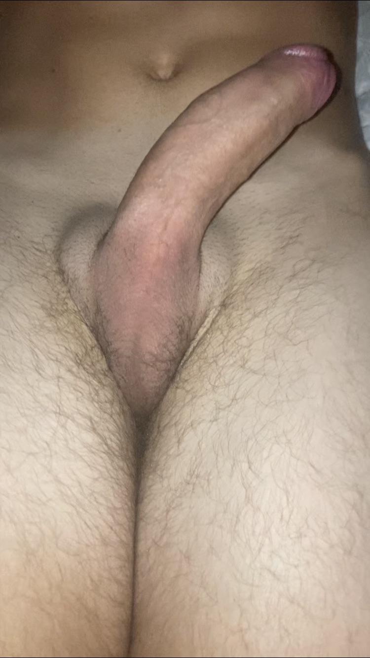 Slim white man posing for close-up selfies of his uncut penis and balls.