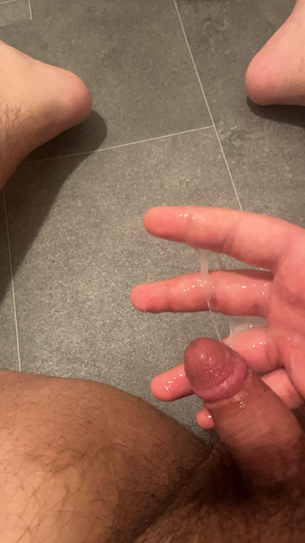 White man from Köln in a bathroom selfie with an erection and cum dripping from his hand
