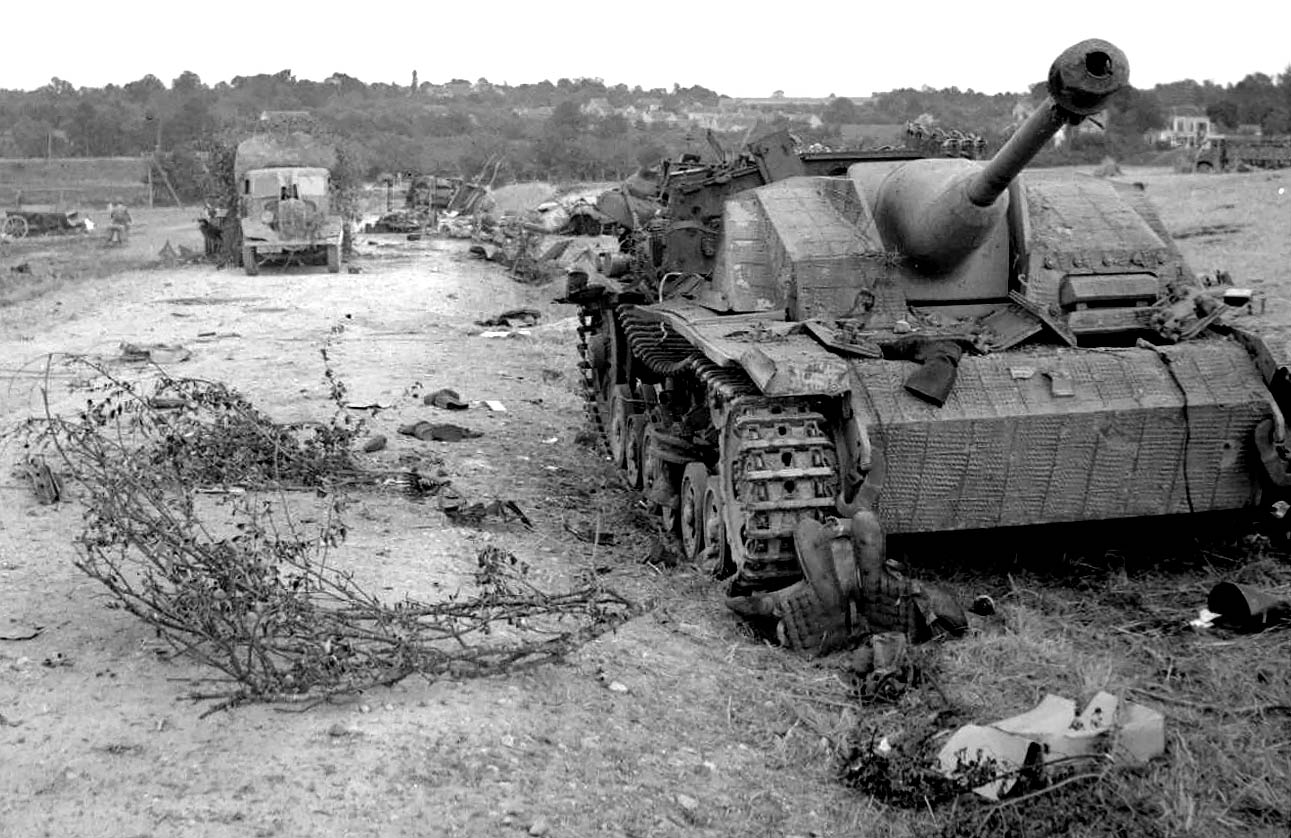 Knocked-out German StuG III assault gun and soft-skin vehicles shot up ...