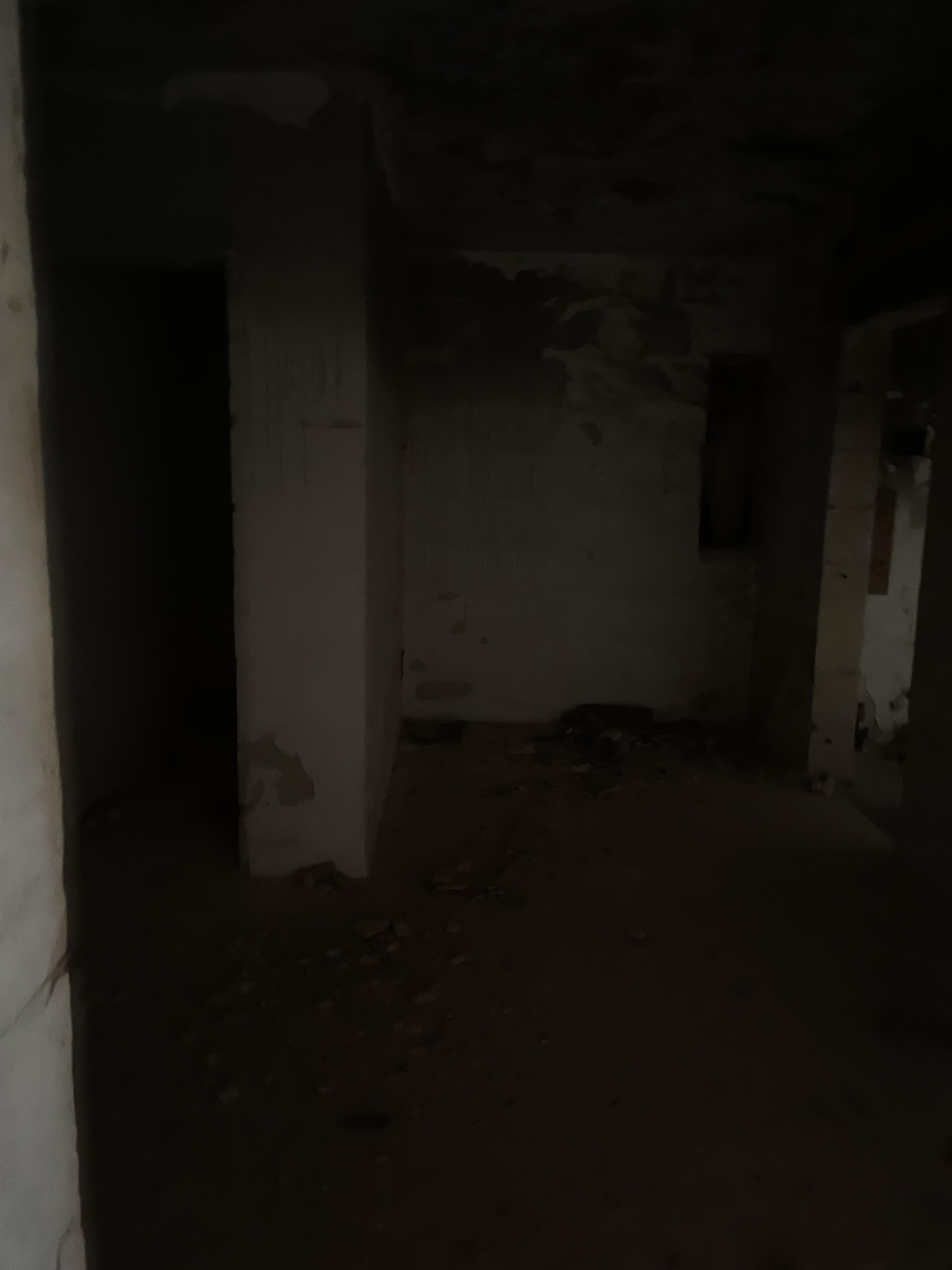 Urban exploration of a derelict 5 storey concrete building in Malta with graffiti and rubble.