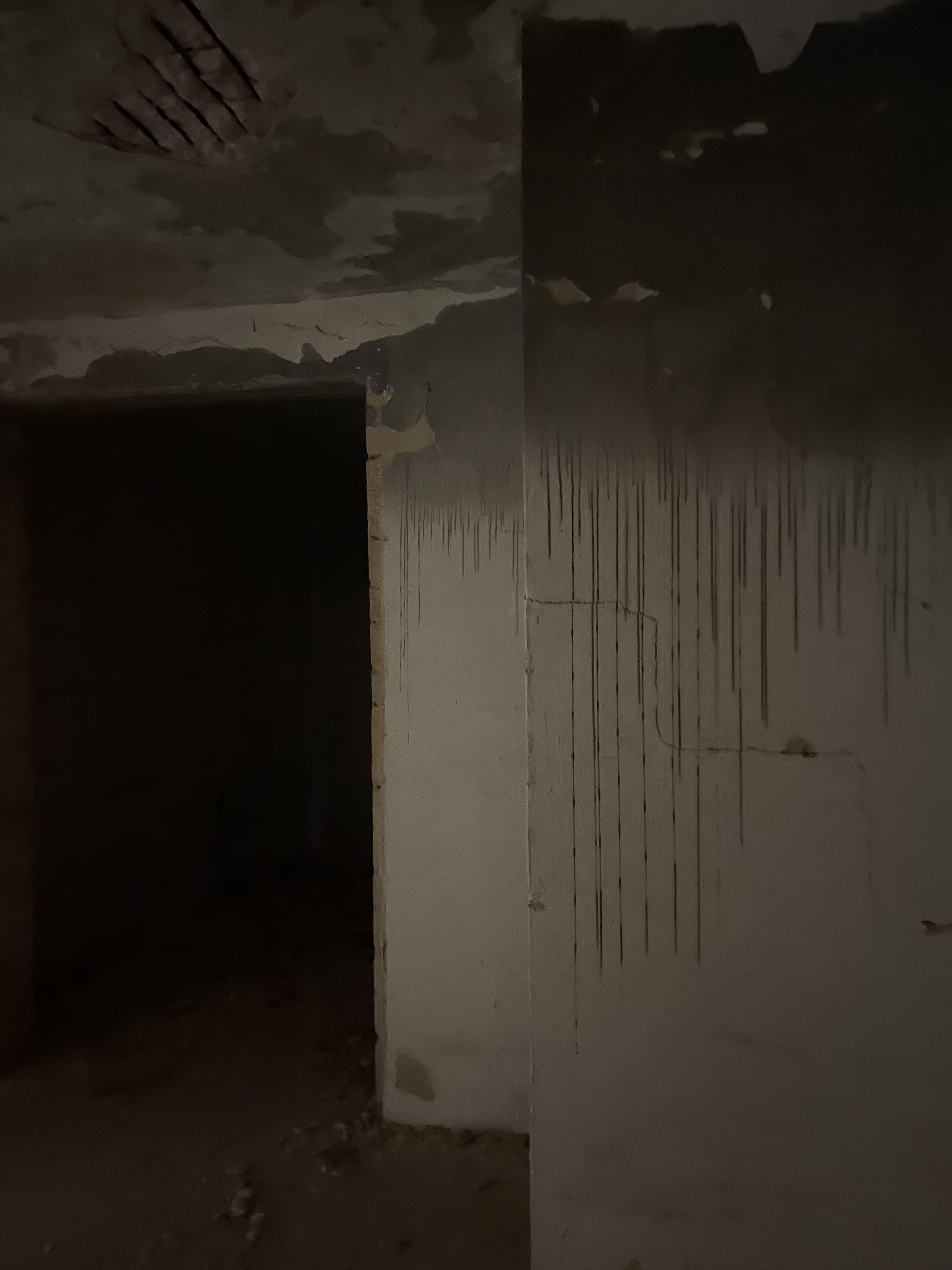 Urban exploration of a derelict 5 storey concrete building in Malta with graffiti and rubble.